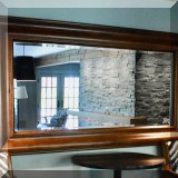 D01. Beveled glass walnut mirror 36”h x 67”w 